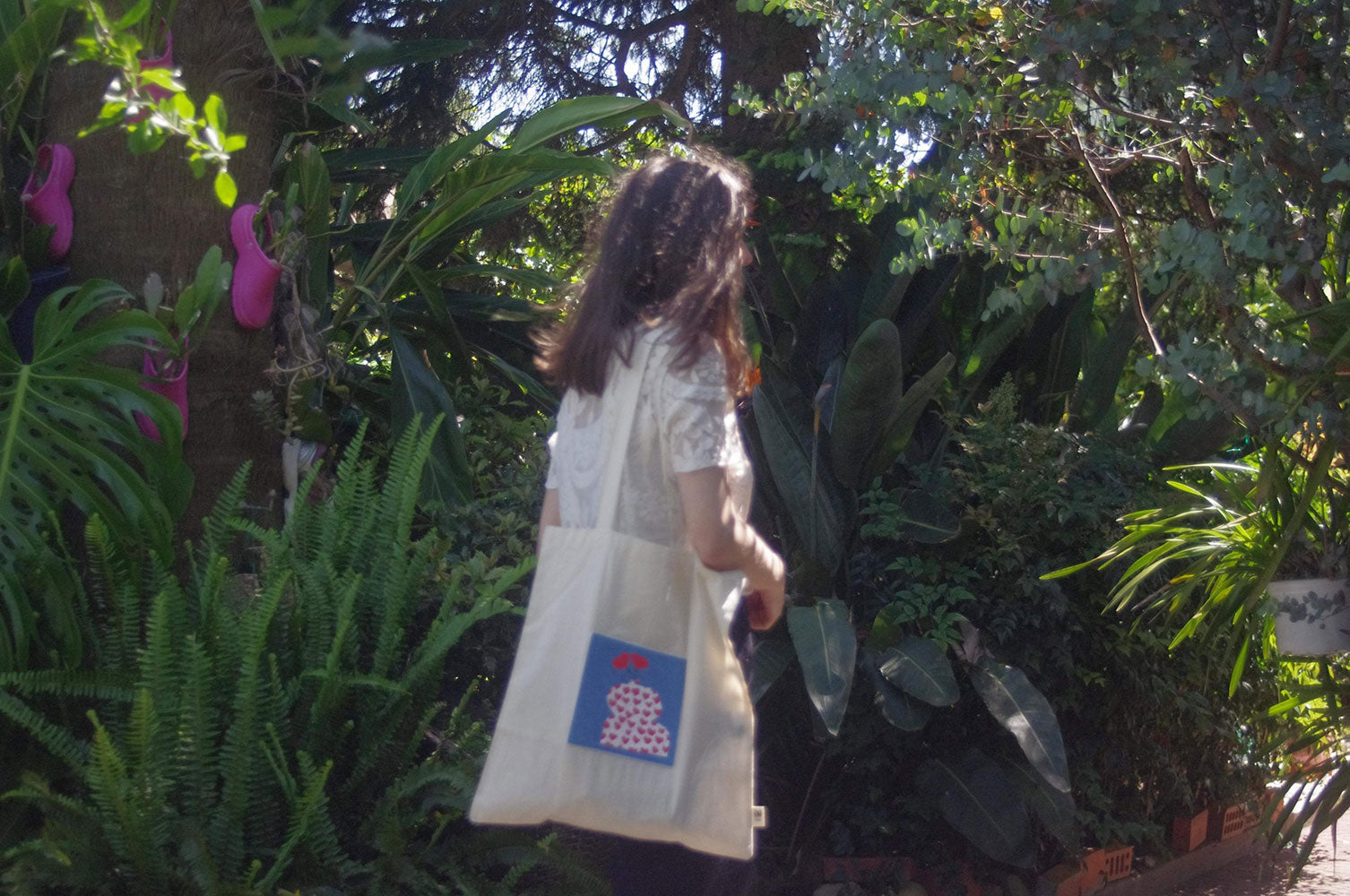 Woman wearing a tote bag with needlepoint insert