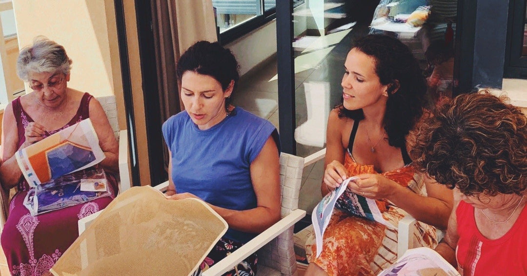 three generations stitching needlepoint together