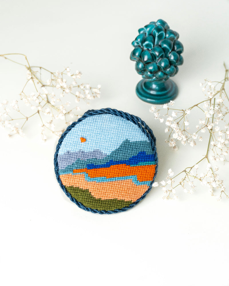 Finished needlepoint ornament of the design Alpine River