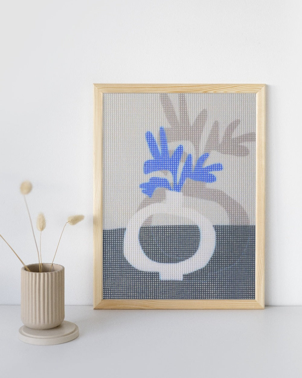 Needlepoint canvas with illustration of blue flower in a gray vase
