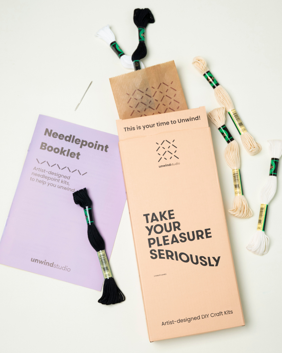 Unwind studio bookmark packaging displayed in a flat lay with exemples of threads and a instructional booklet
