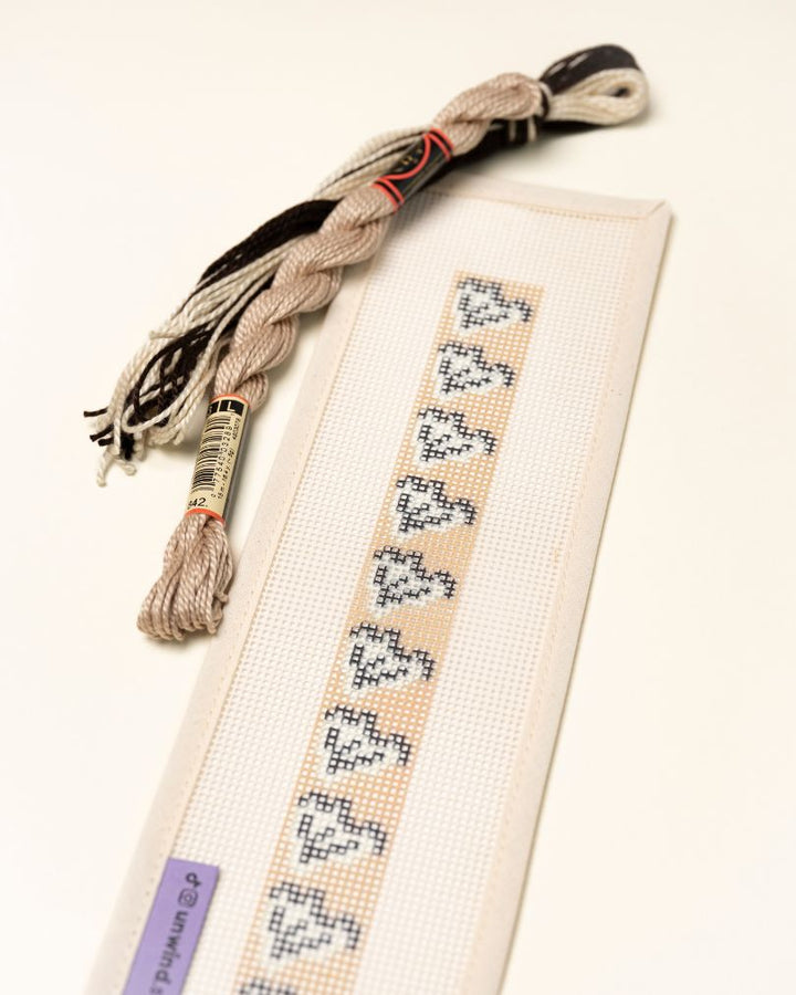 Up-close view of the Clay Leaf Key Fob Needlepoint Kit with matching threads
