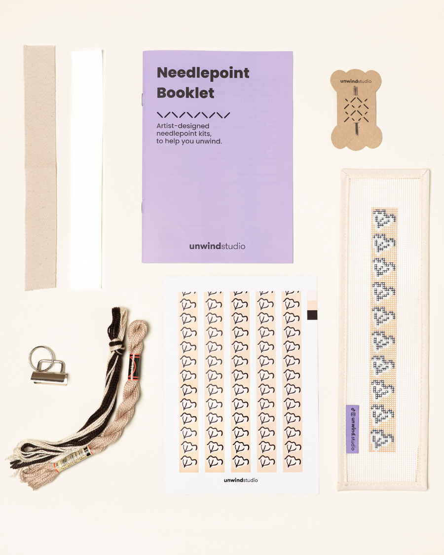 Caly Leaf Complete Needlepoint Kit with finishing materials such as fusible web and cotton twill tape, key fob hardware plus matching threads, set of needles, a graphic flyer and a instructional booklet.