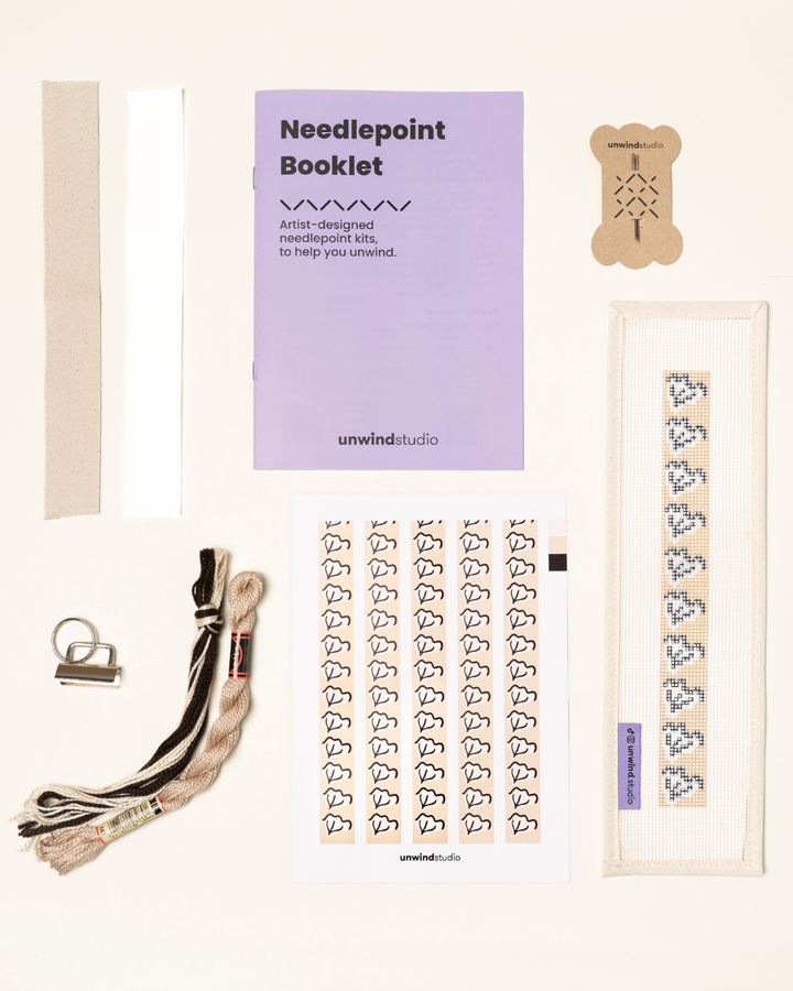 Caly Leaf Complete Needlepoint Kit with finishing materials such as fusible web and cotton twill tape, key fob hardware plus matching threads, set of needles, a graphic flyer and a instructional booklet.