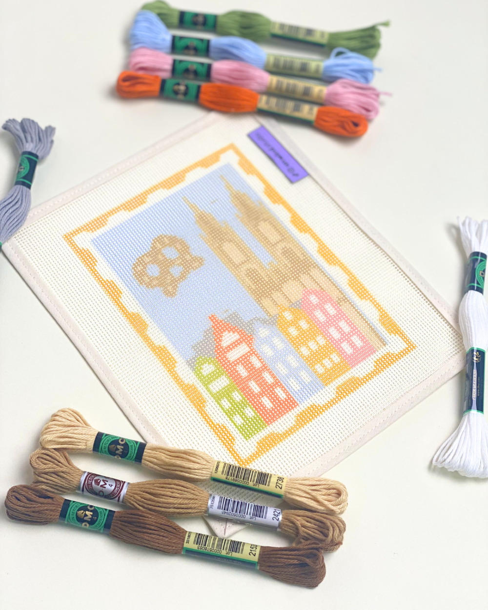 Cologne Stamp Needlepoint Kit with threads displayed closed up