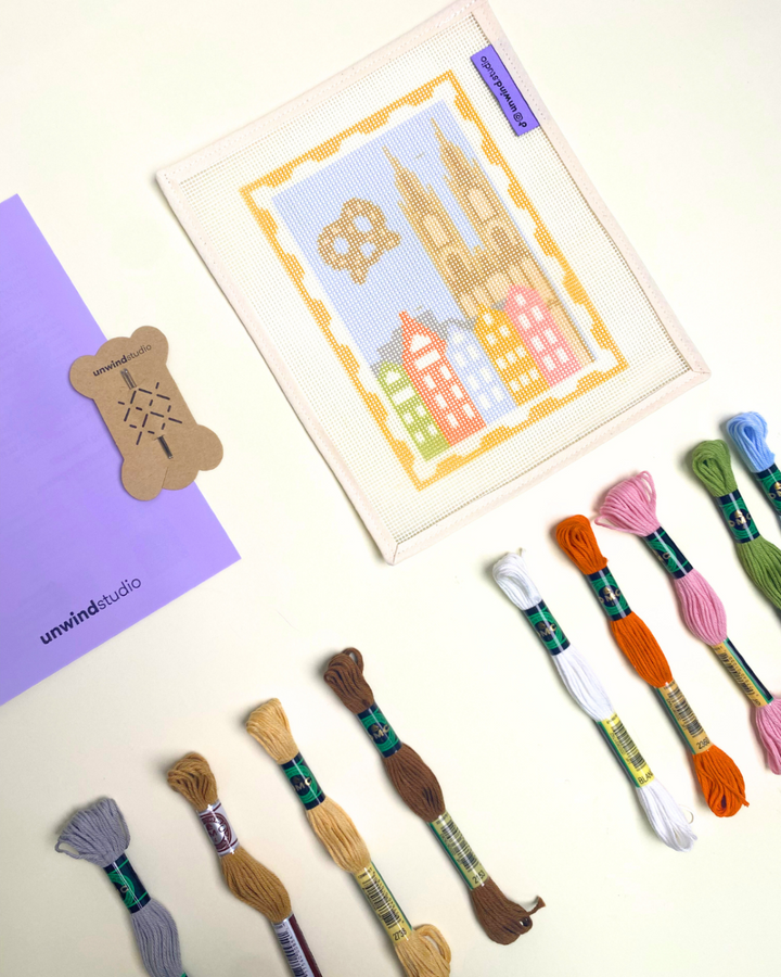 Cologne Stamp Needlepoint Kit with threads, needles and booklet.