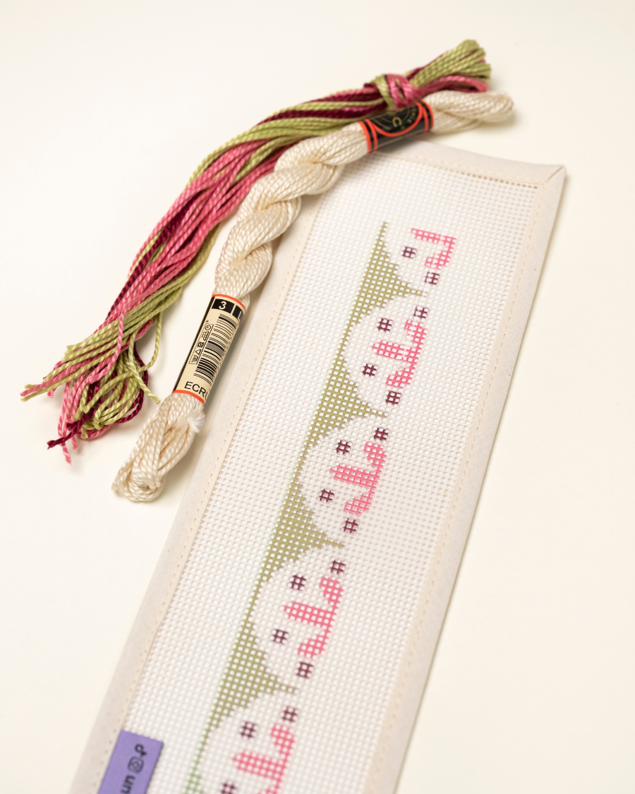 Up-close view of the Flourish Key Fob Needlepoint Kit with matching threads