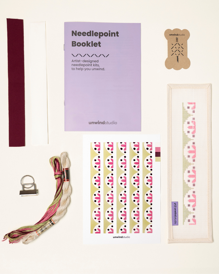 Flourish Complete Needlepoint Kit with finishing materials such as fusible web and cotton twill tape, key fob hardware plus matching threads, set of needles, a graphic flyer and a instructional booklet.