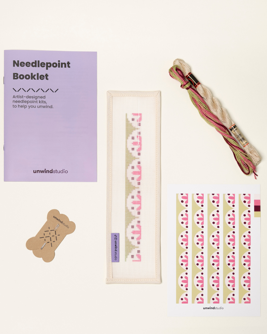 flat view of the Flourish Key Fob Needlepoint Kit with printed canvas, matching threads, a instructional booklet and a graphic flyer