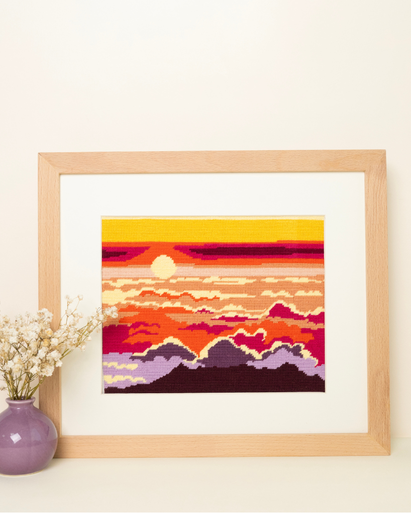 The Haleakala National Park from Unwind Studio placed on a wood frame with a purple dry flower vase next to it