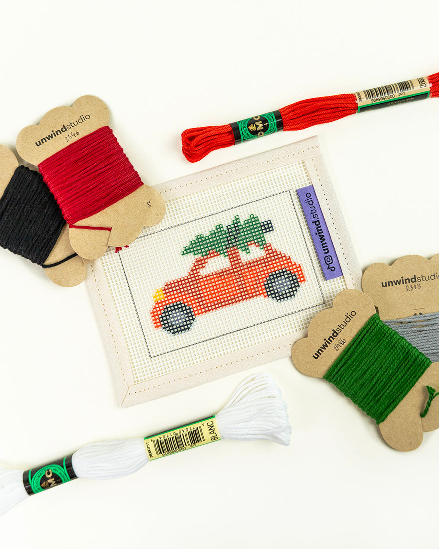 needlepoint kit with a Christmas car design and colorful threads 