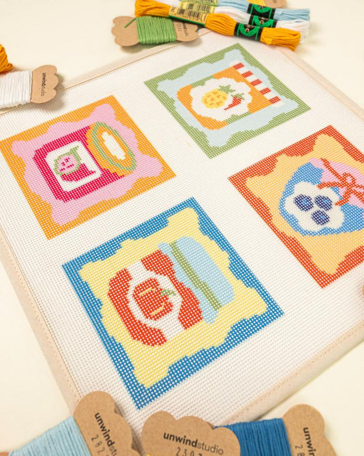 Close-up perspective of the jam coaster collection, showing the harmony between the colorful canvas patterns and the curated thread palette.