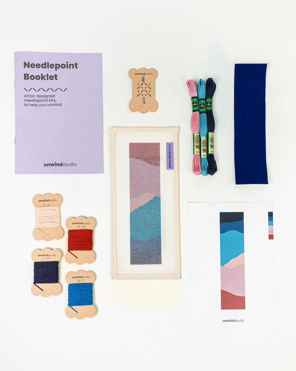 Complete needlepoint bookmark kit for the Nightfall Mountain design, including the canvas, a instructional booklet, DMC Soft Cotton Threads, finishing materials and flyer.