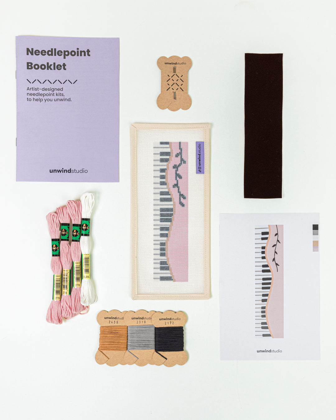 Complete needlepoint bookmark kit for Piano Forte design, including the canvas, a instructional booklet, DMC Soft Cotton Threads, finishing materials and flyer.