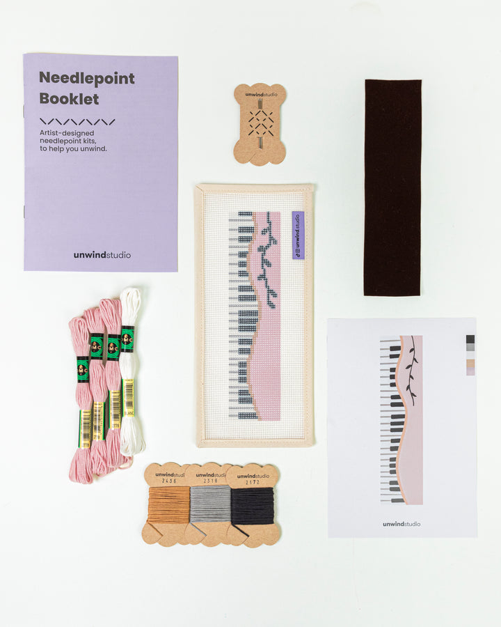 Complete needlepoint bookmark kit for Piano Forte design, including the canvas, a instructional booklet, DMC Soft Cotton Threads, finishing materials and flyer.