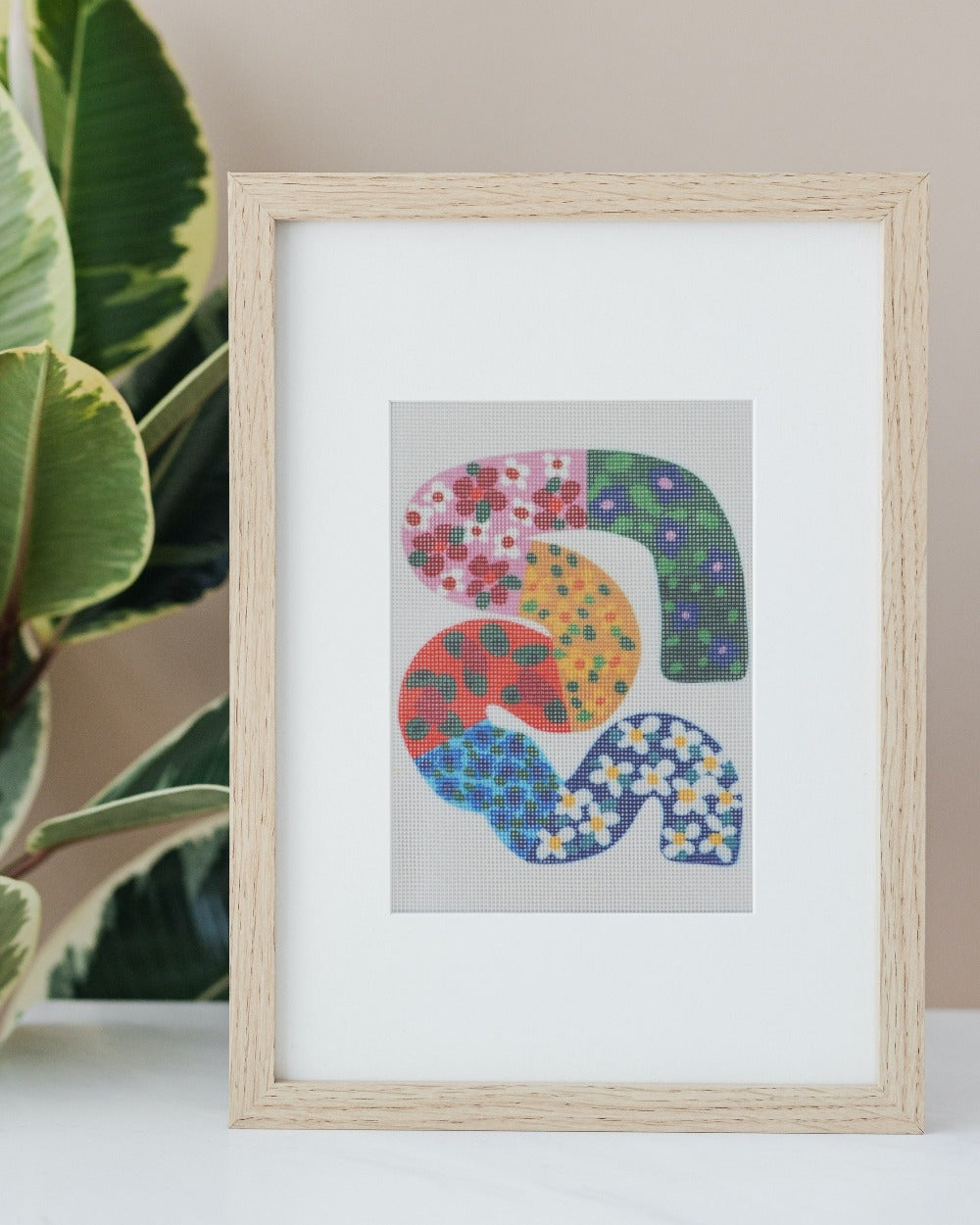 Sunflower abstract and floral design for a needlepoint kit by Unwind Studio in collaboration with artist Melanie Macilwain. Needlepoint piece framed for home decor