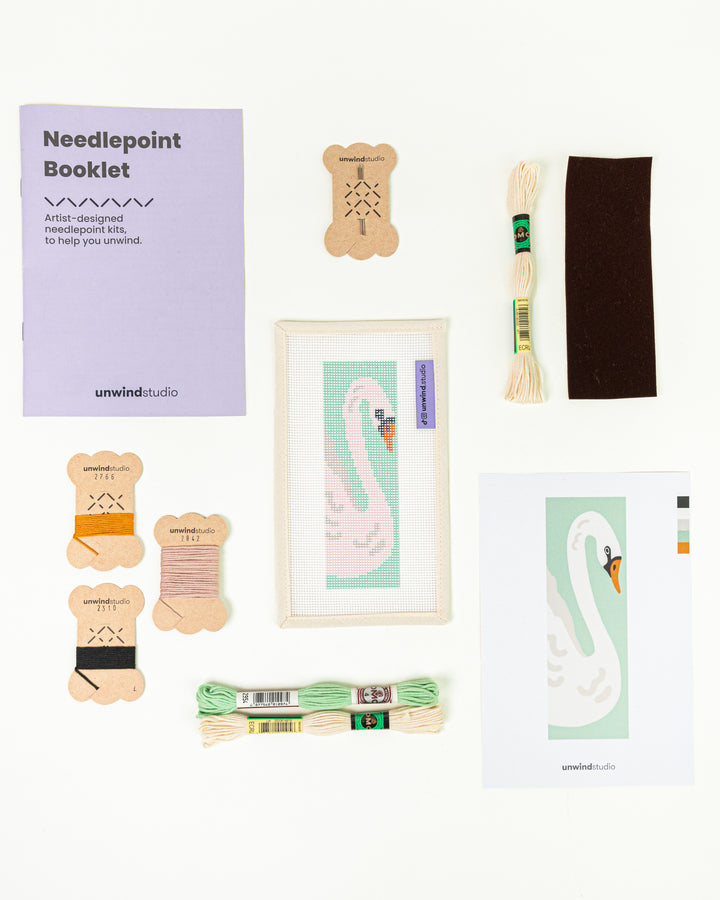 Complete needlepoint bookmark kit for The White Swan design, including the canvas, a instructional booklet, DMC Soft Cotton Threads, finishing materials and flyer.