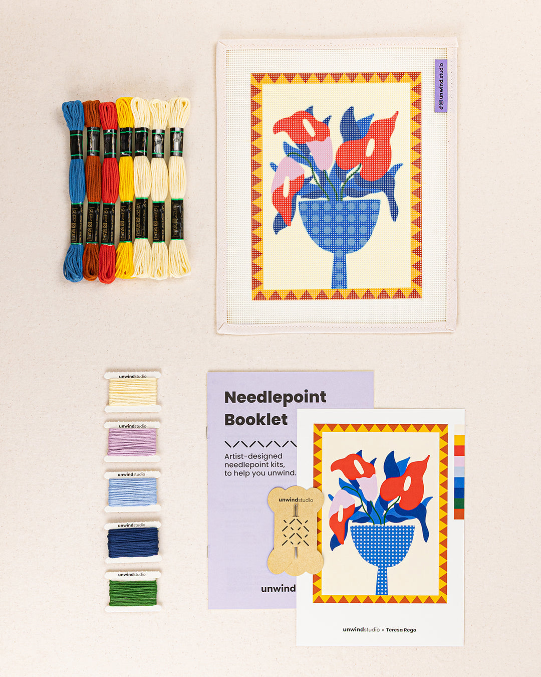 anthurium needlepoint kit contents: printed canvas, threads, needles, and instruction booklet, graphic flyer laid flat