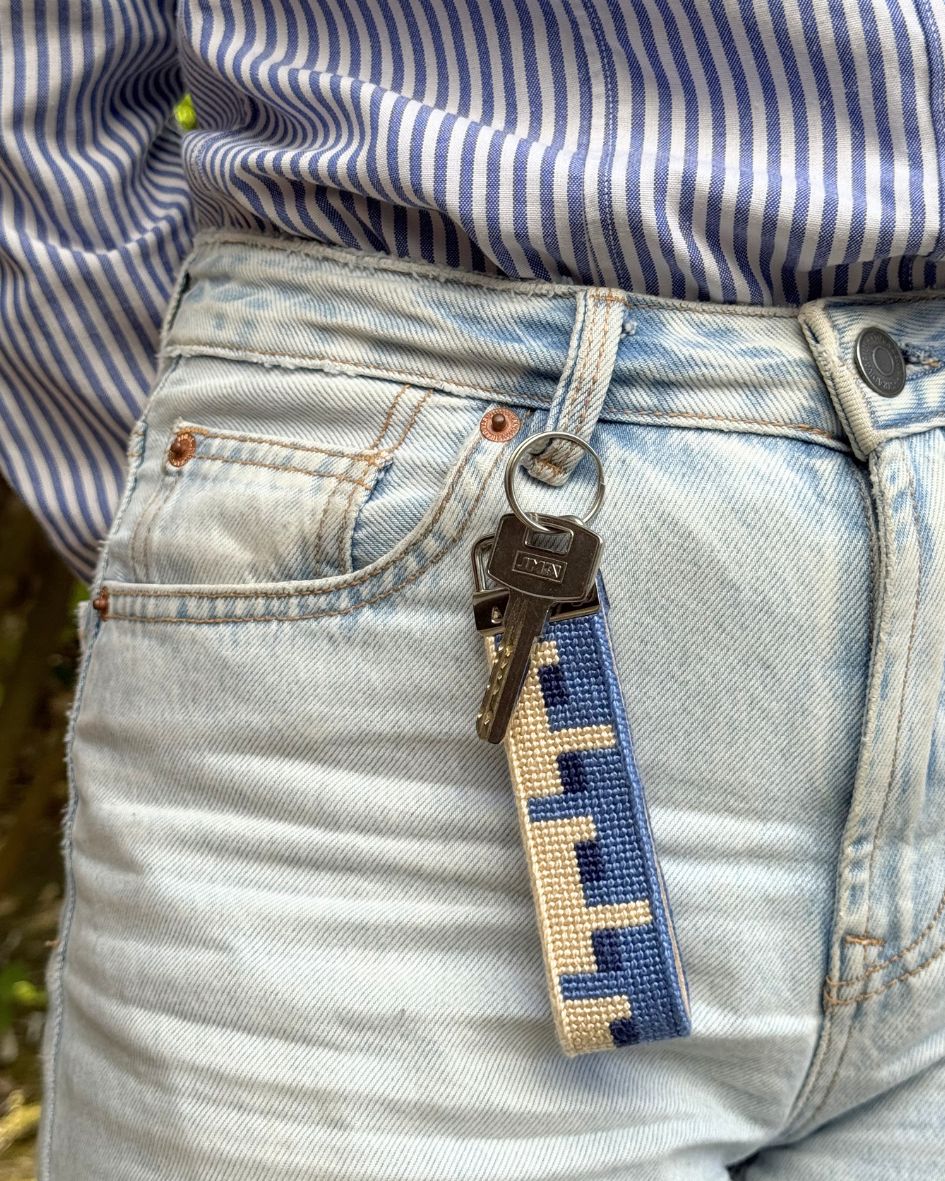 Echo Key Fob with a key hanging on a pair of denim jeans
