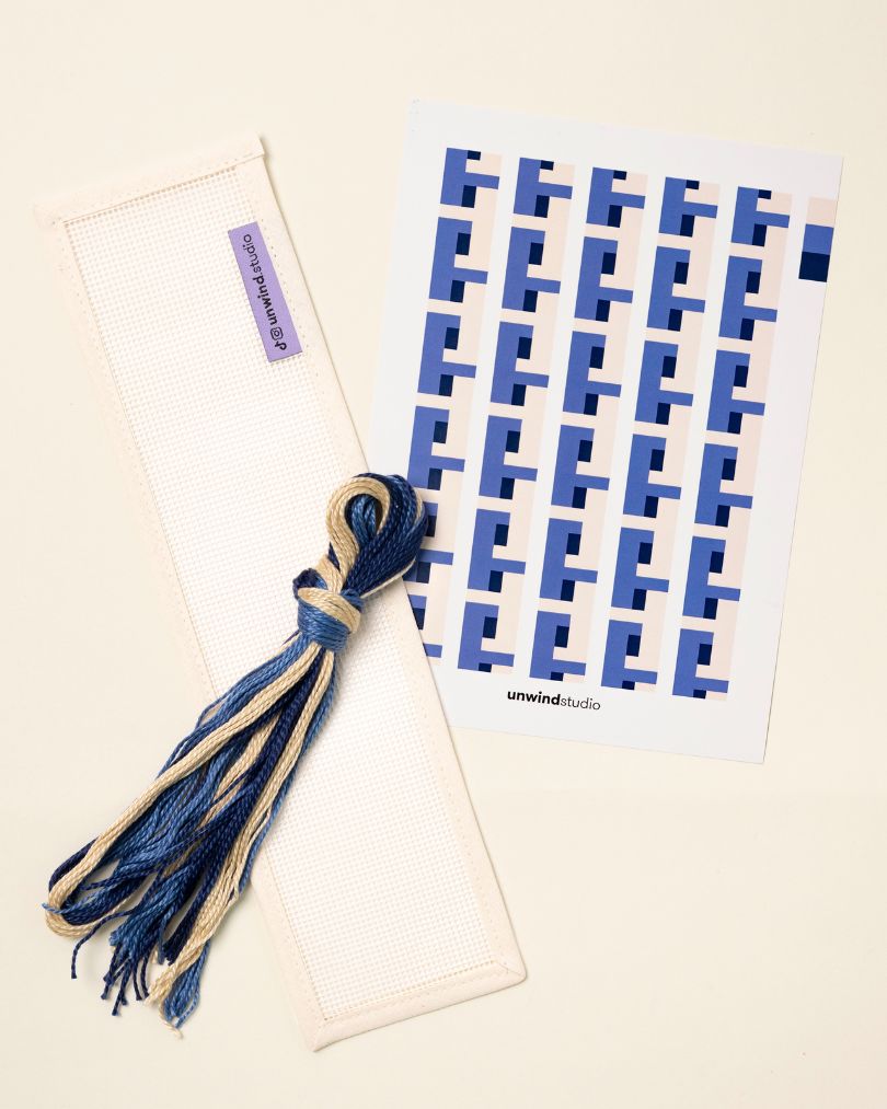 flat view of the Batik Key Fob Needlepoint Kit with blank canvas, matching threads and a graphic flyer

