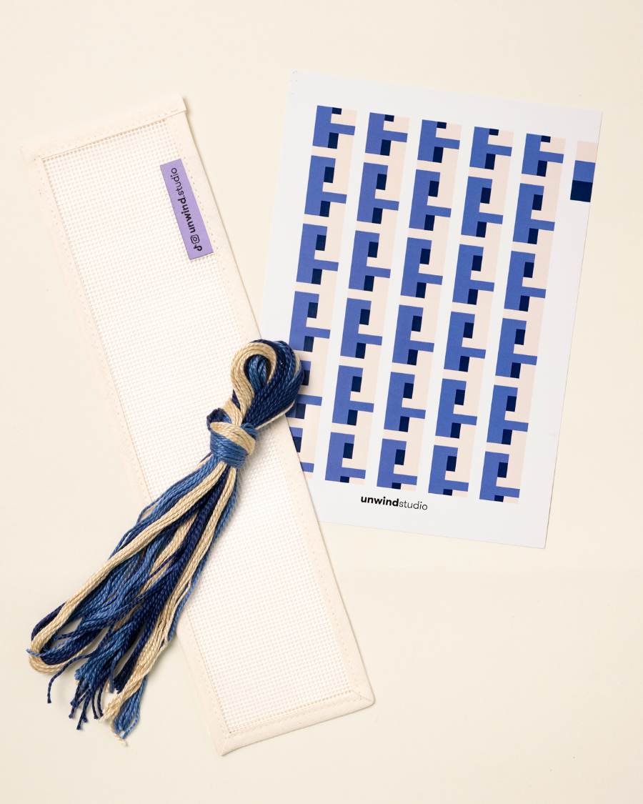 flat view of the Batik Key Fob Needlepoint Kit with blank canvas, matching threads and a graphic flyer