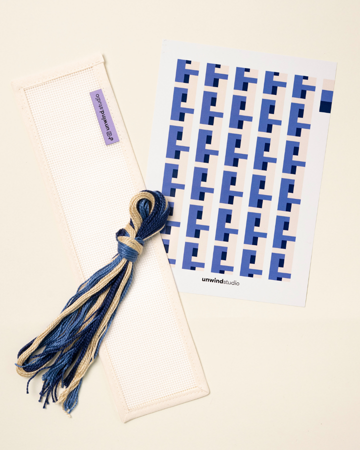 flat view of the Batik Key Fob Needlepoint Kit with blank canvas, matching threads and a graphic flyer