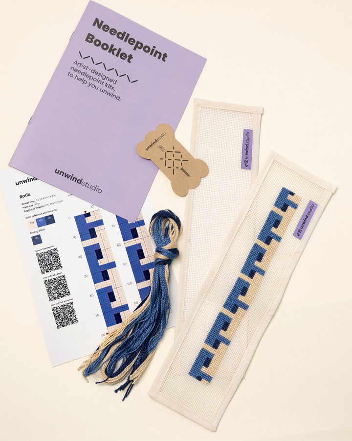 flat view of the Batik Key Fob Needlepoint Kit with blank canvas, matching threads, a instructional booklet and a graphic flyer