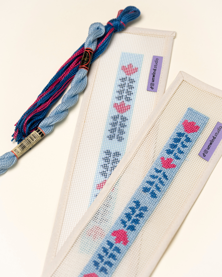 Berry Vine Key Fob Needlepoint Kit placed next to a already stitch version of it paired with matching threads