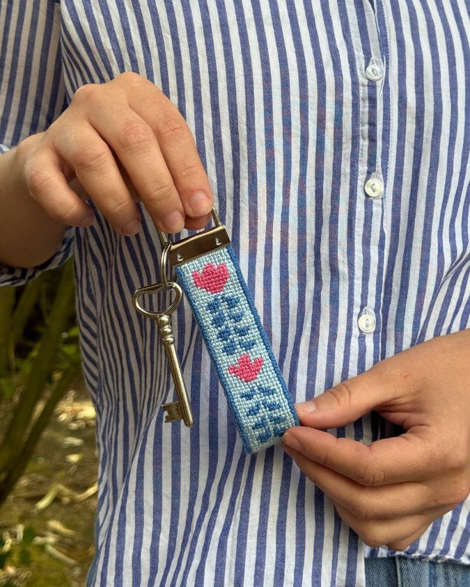Berry Vine Key Fob with a key being held by a pair of hands on a blue stripped shirt background