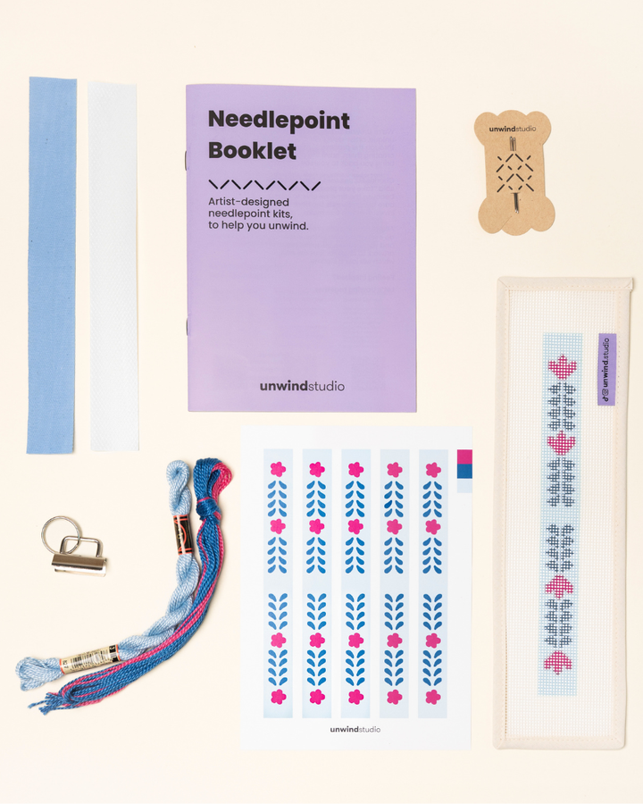 Berry Vine Complete Needlepoint Kit with finishing materials such as fusible web and cotton twill tape, key fob hardware plus matching threads, set of needles, a graphic flyer and a instructional booklet.