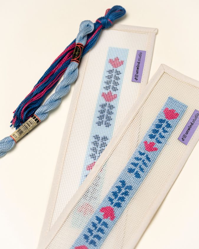 Berry Vine Key Fob Needlepoint Kit placed next to a already stitch version of it paired with matching threads
