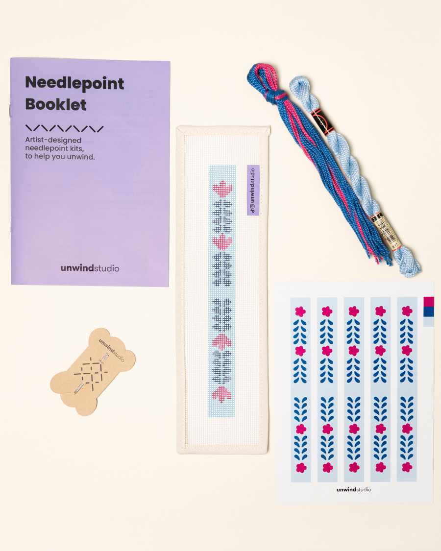 flat view of the Berry Vine Key Fob Needlepoint Kit with printed canvas, matching threads, a instructional booklet and a graphic flyer