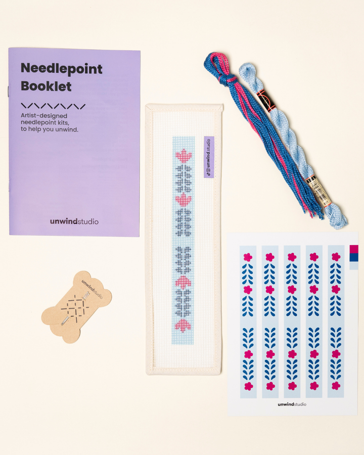 flat view of the Berry Vine Key Fob Needlepoint Kit with printed canvas, matching threads, a instructional booklet and a graphic flyer