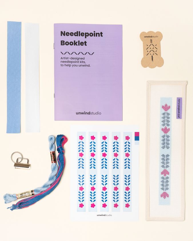 Berry Vine Complete Needlepoint Kit with finishing materials such as fusible web and cotton twill tape, key fob hardware plus matching threads, set of needles, a graphic flyer and a instructional booklet.