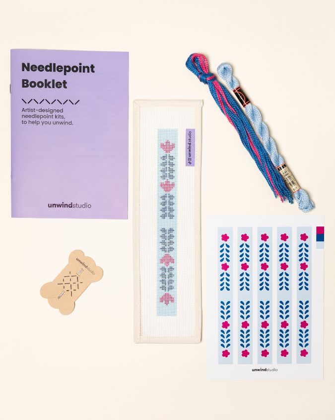 flat view of the Berry Vine Key Fob Needlepoint Kit with printed canvas, matching threads, a instructional booklet and a graphic flyer
