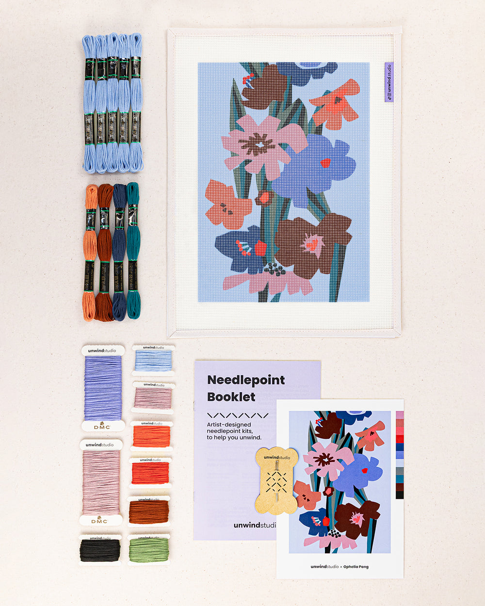 Blooming in the dark needlepoint kit contents: printed canvas, threads, needles, and instruction booklet, graphic flyer laid flat