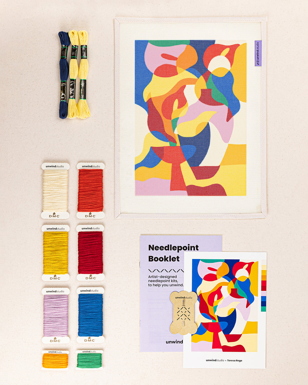 bloomware needlepoint kit contents: printed canvas, threads, needles, and instruction booklet, graphic flyer laid flat