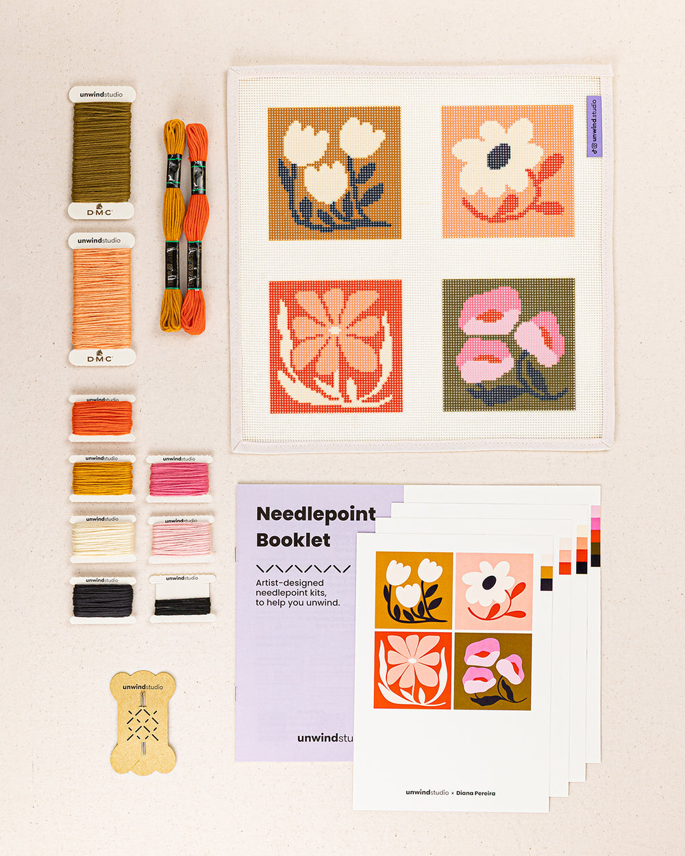 Blossom Coaster Set needlepoint kit contents: printed canvas, threads, needles, and instruction booklet, graphic flyer laid flat
