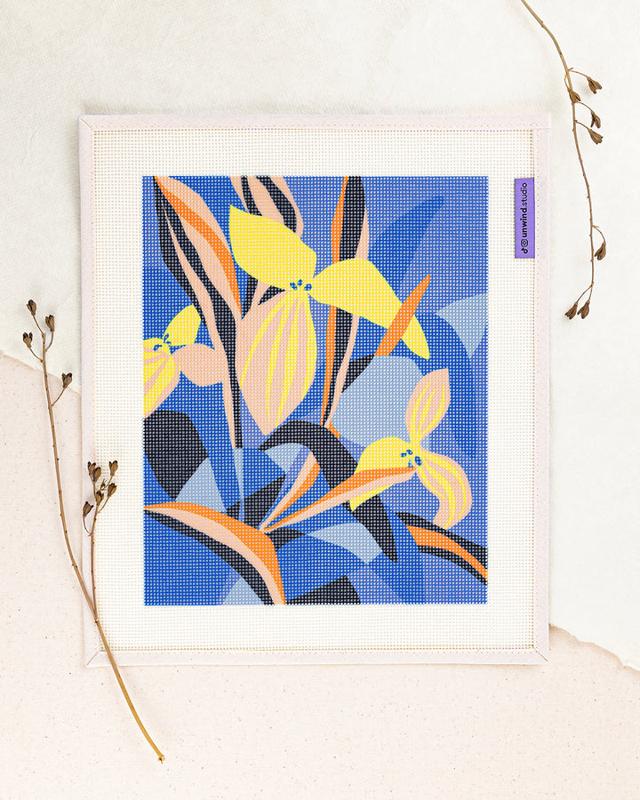 Blue Delight needlepoint kit by Ophelia Pang: printed canvas of yellow flowers on blue, framed with dried twigs
