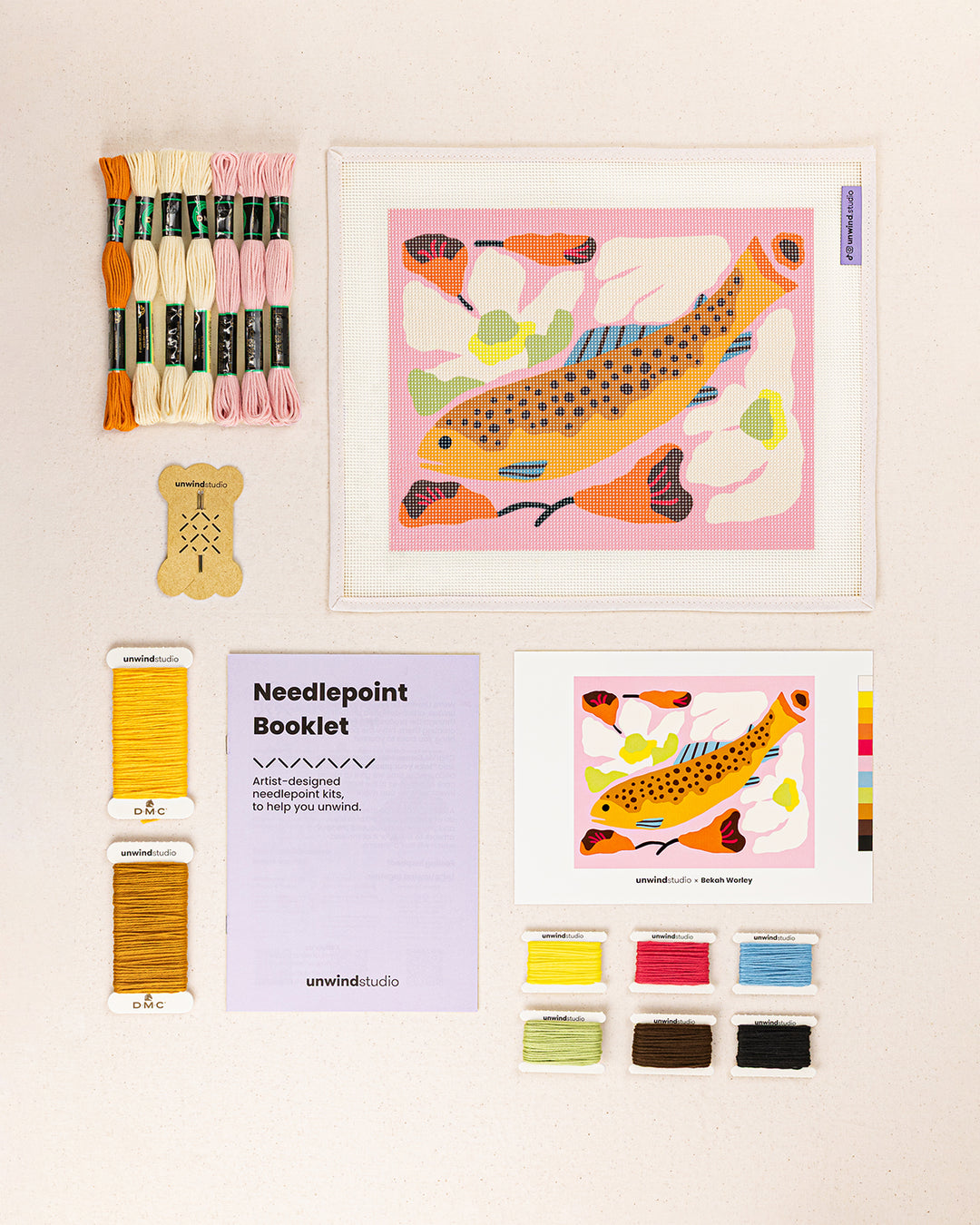 Brook Trout needlepoint kit contents: printed canvas, threads, needles, and instruction booklet, graphic flyer laid flat
