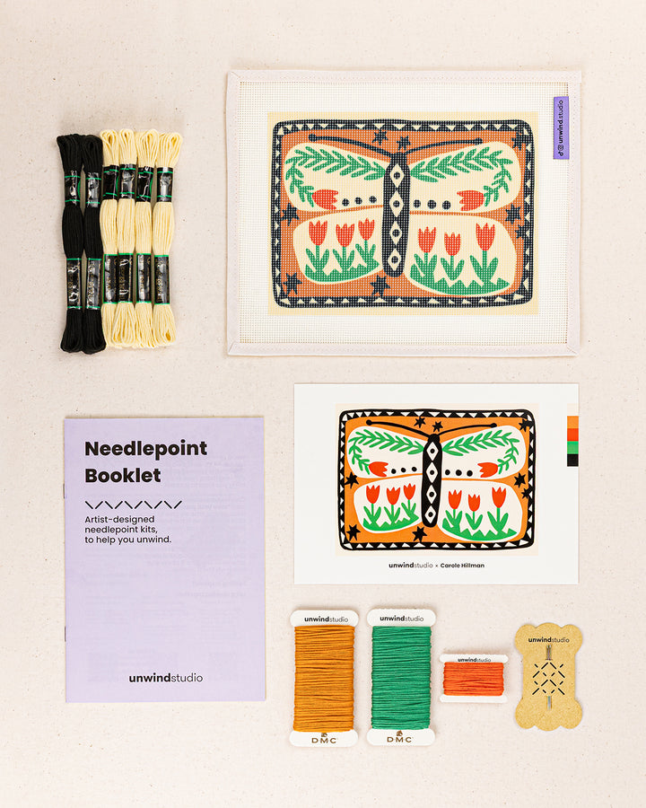 folk butterfly needlepoint kit contents: printed canvas, threads, needles, and instruction booklet, graphic flyer laid flat