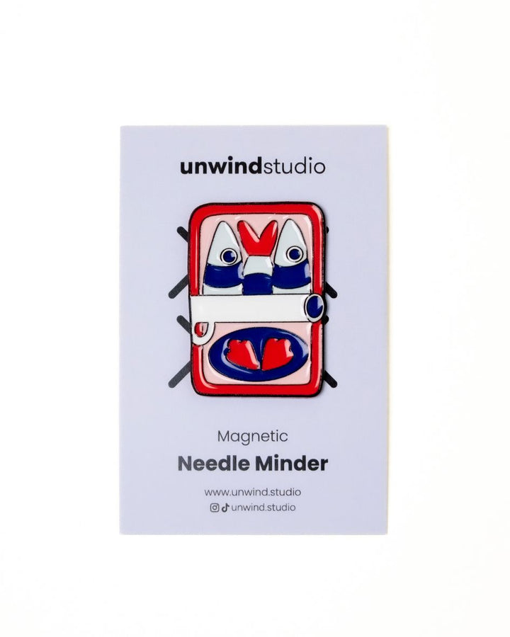 The unwind studio needle minder can of sardines magnet place on a personalized card.

