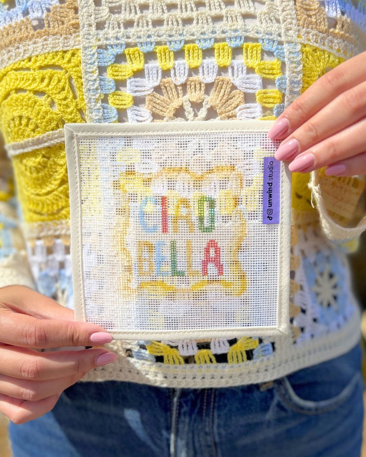 close-up shot of unwind studio Ciao Bella Coaster Needlepoint Canvas in a colorful background.