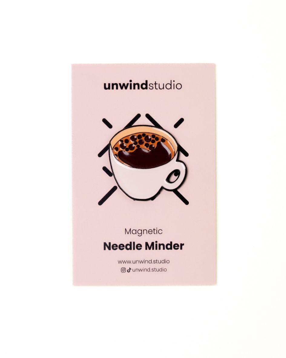 The unwind studio needle minder coffee (bica) magnet place on a personalized card.

