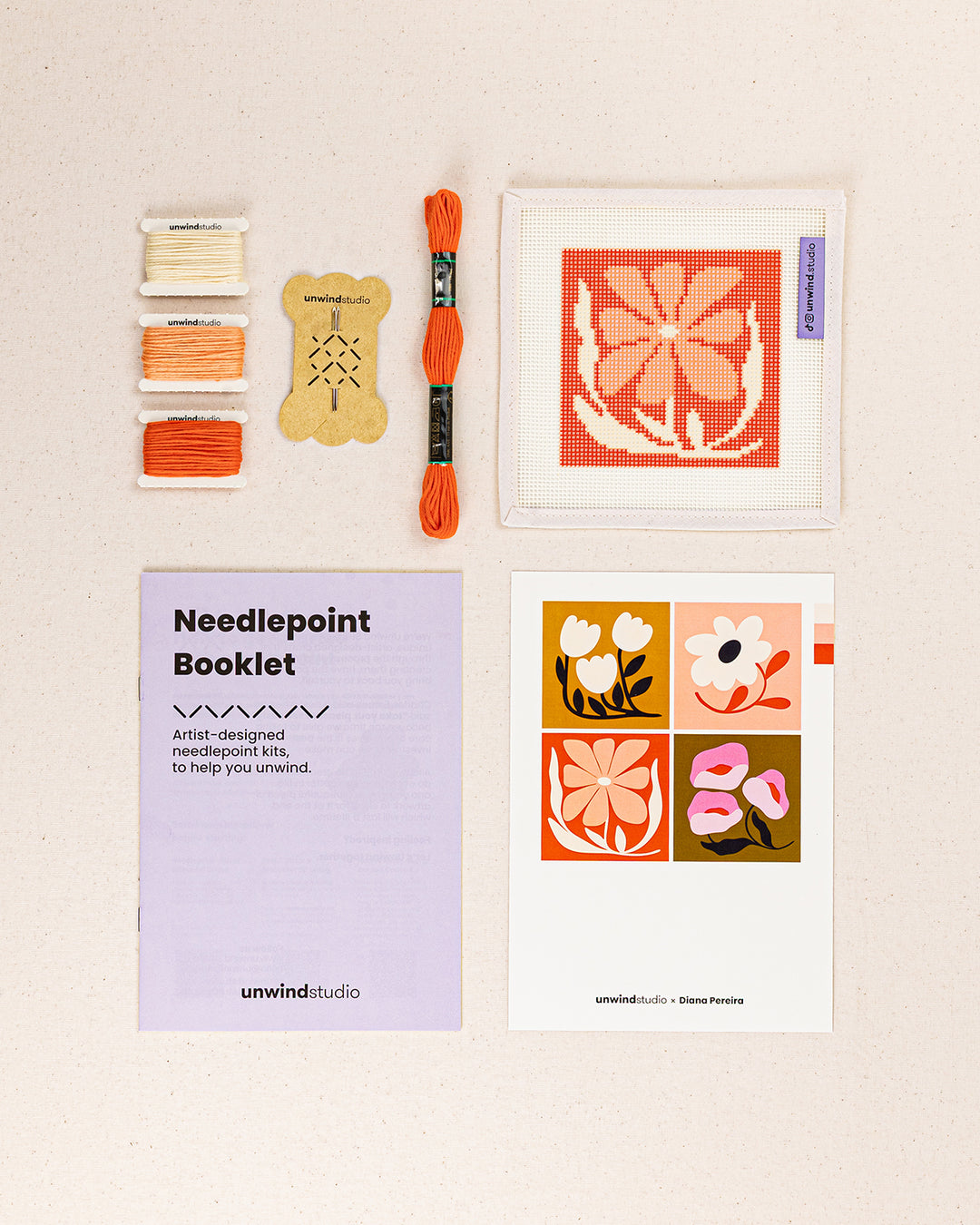 coral bloom needlepoint kit contents: printed canvas, threads, needles, and instruction booklet, graphic flyer laid flat