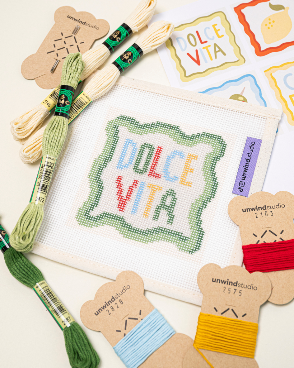 diagonal flat lay of the dolce vita coaster paired with matching DMC soft cotton threads.