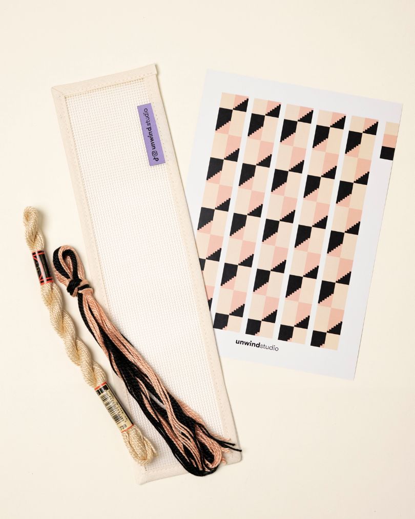 flat view of the Echo Key Fob Needlepoint Kit with blank canvas, matching threads and a graphic flyer
