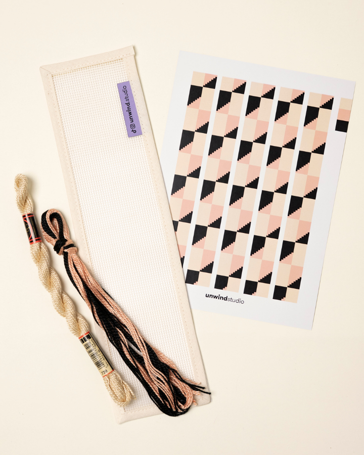 flat view of the Echo Key Fob Needlepoint Kit with blank canvas, matching threads and a graphic flyer