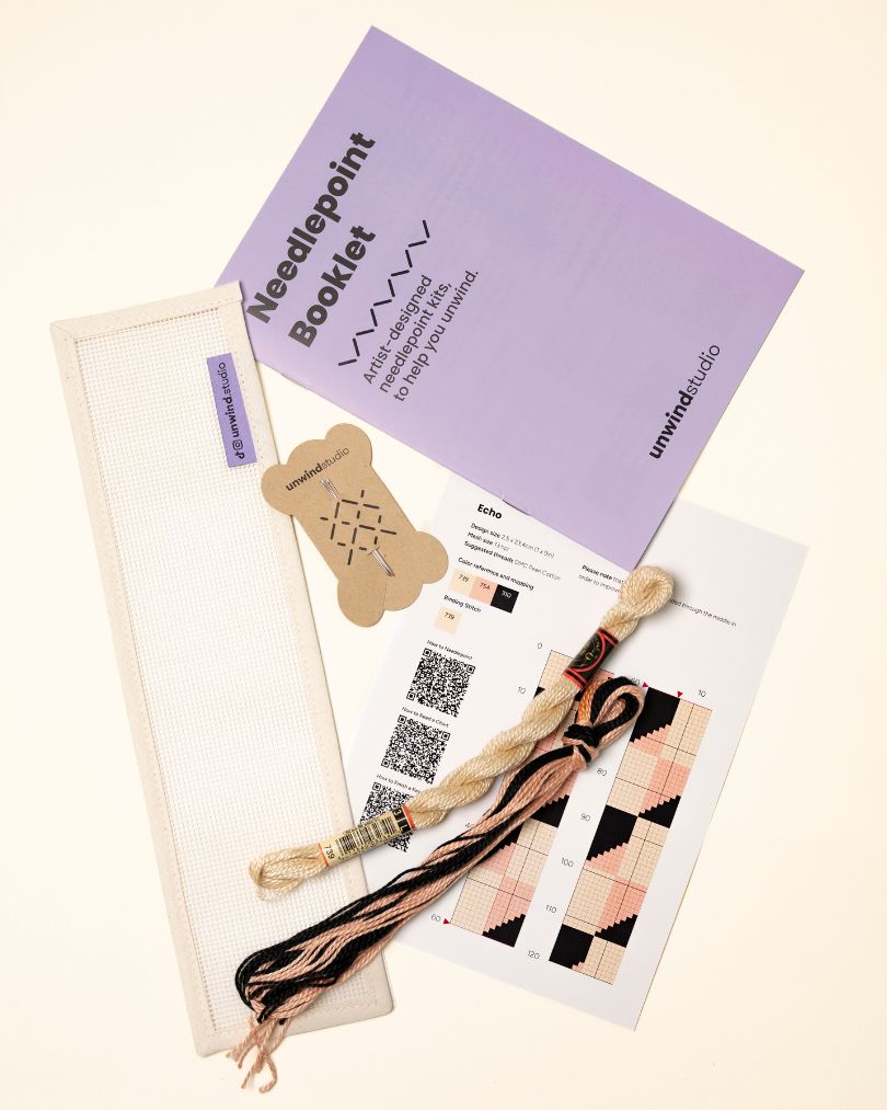 flat view of the Echo Key Fob Needlepoint Kit with blank canvas, matching threads and instructional booklet
