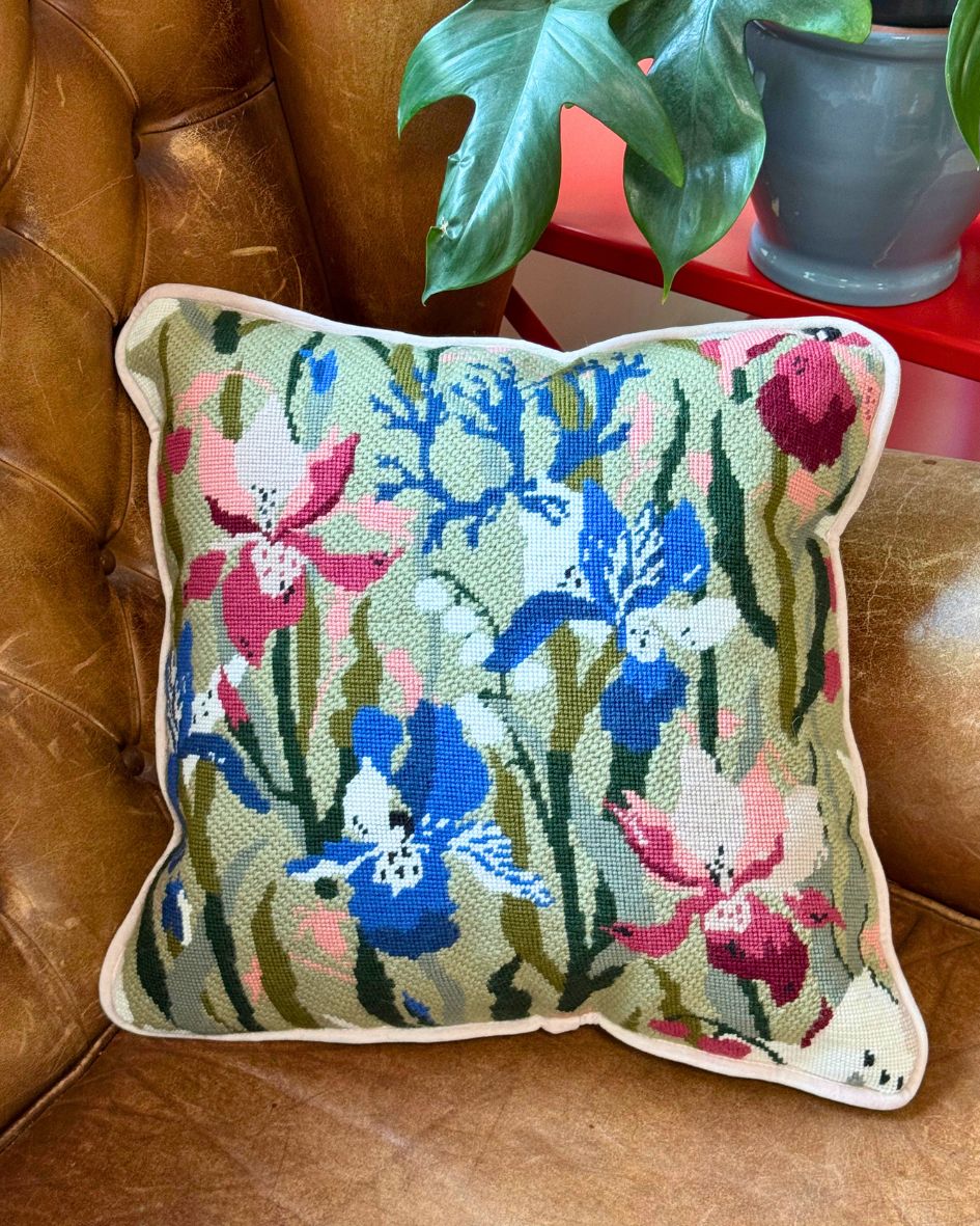 floral rhapsody cushion finished placed on a brown sofa